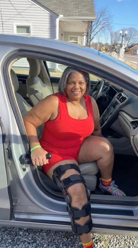Using the car exit assist handle at the car door