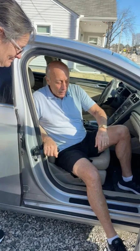 Holding the car exit assist handle while getting out of the car